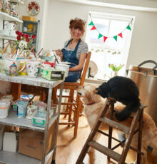 Kate painting in her studio with cat and dog